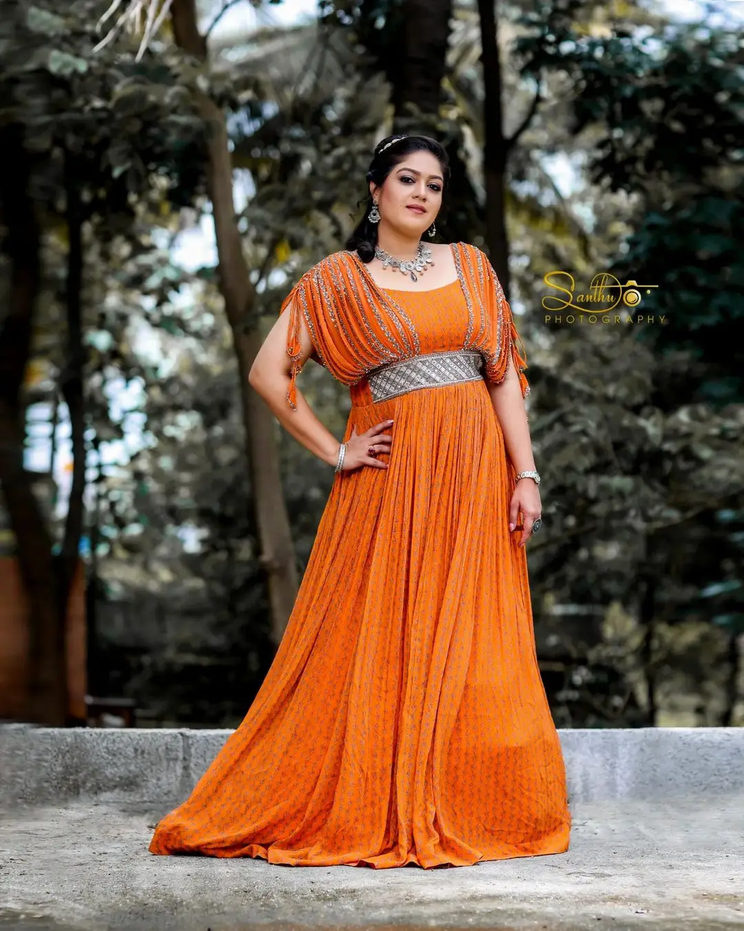 Meghana Raj Wearing Beautiful Earring Jewellery Orange Gown